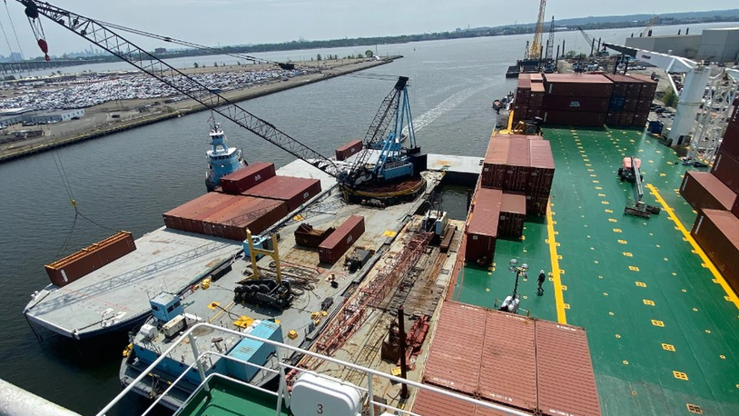 Vehicles, containers removed from fire-damaged ship