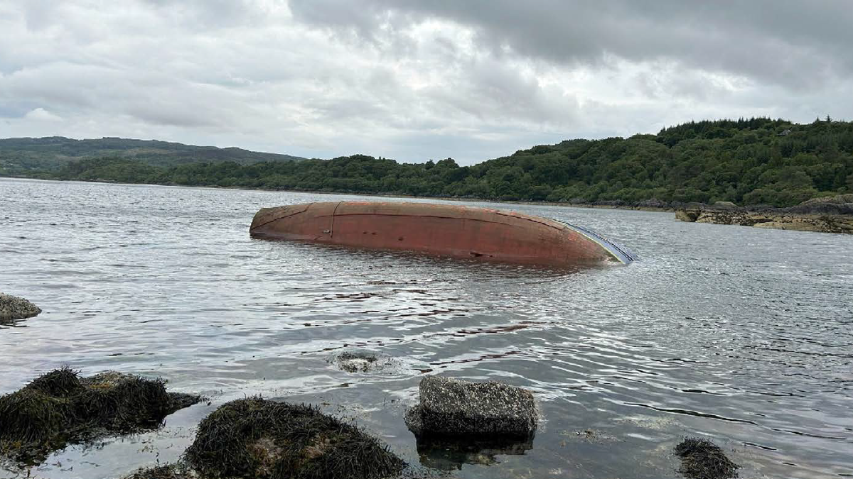 Crystal Stream lying on its port side, partially submerged at Barmore Island, Loch Fyne, Scotland (source: MAIB)&nbsp;